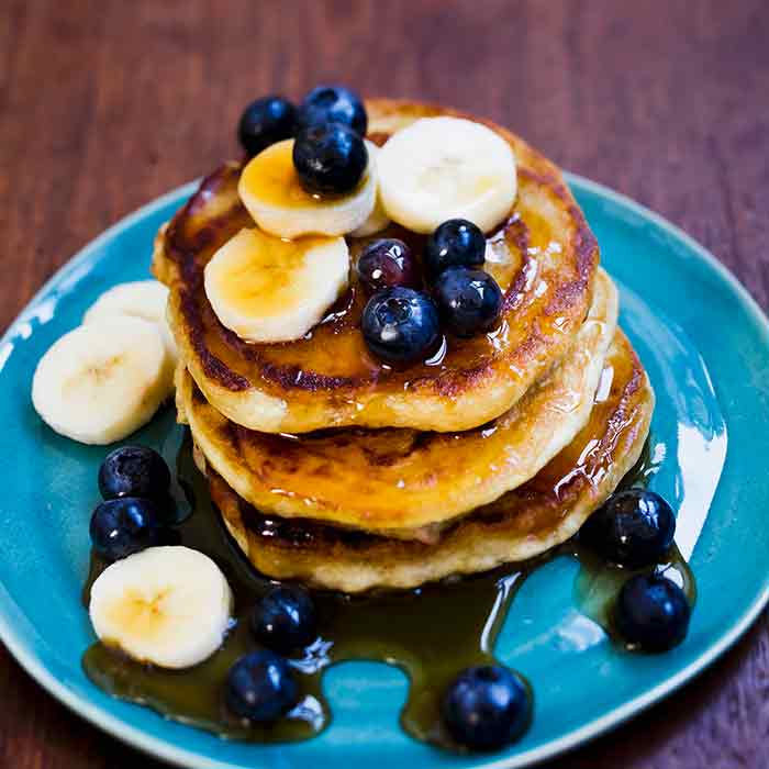 Pancakes with berries, blueberries and maple syrup
